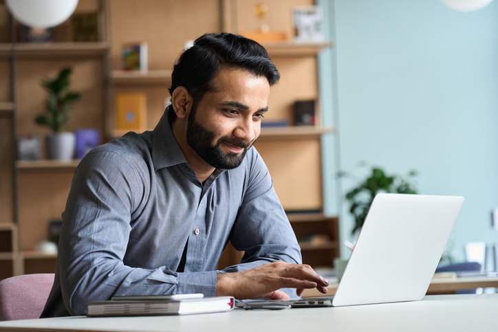 Professional choosing and confirming meetings on a laptop