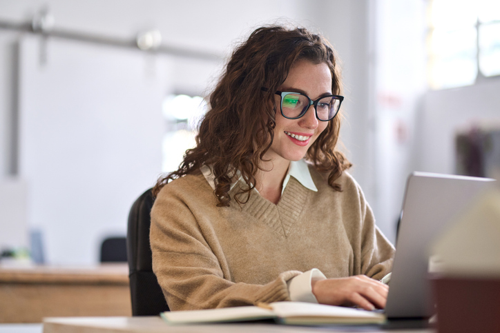 Professional completing an online profile on a laptop
